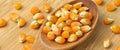 Yellow maize corn kernels ready for making popcorn, on bamboo cutting board and in wooden spoon Royalty Free Stock Photo