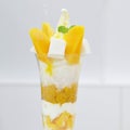 Yellow mango parfait ice-cream in tall glass.