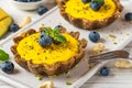 Yellow mango vegan raw cakes with blueberries, mint and nuts. healthy delicious food Royalty Free Stock Photo