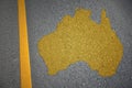 yellow map of australia country on asphalt road near yellow line.