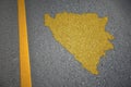 yellow map of bosnia and herzegovina country on asphalt road near yellow line