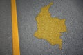 yellow map of colombia country on asphalt road near yellow line.