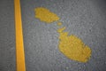 yellow map of malta country on asphalt road near yellow line
