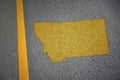 yellow map of montana state on asphalt road near yellow line Royalty Free Stock Photo