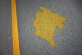 yellow map of montenegro country on asphalt road near yellow line