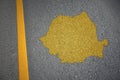 yellow map of romania country on asphalt road near yellow line