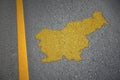 yellow map of slovenia country on asphalt road near yellow line