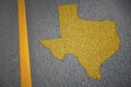 yellow map of texas state on asphalt road near yellow line Royalty Free Stock Photo