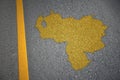 yellow map of venezuela country on asphalt road near yellow line.