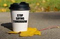 On a yellow maple leaf there is a cup of coffee on which is written - Stop saying tomorrow