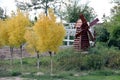 Yellow maples in autumn and small wooden mill