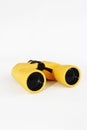 Yellow marine optical plastic binoculars on a white background