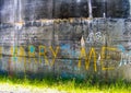 Yellow MARRY ME graffiti painted on old concrete wall of water reservoir