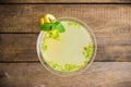 Yellow martini cocktail with lemon and mint