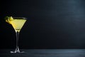 Yellow martini cocktail with lemon and mint