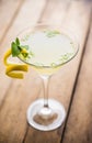 Yellow martini cocktail with lemon and mint