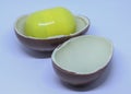 Yellow Maxi Kinder Egg toy box and two side of chocolate shells. Royalty Free Stock Photo