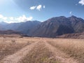 Yellow meadow with highway and mountains