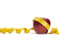 Yellow measure tape around a red apple as a weight loss concept Royalty Free Stock Photo