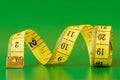 Yellow measure tape on green Royalty Free Stock Photo