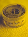 Yellow measuring tape in round plastic box on the towel Royalty Free Stock Photo