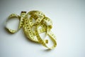 Yellow measuring tape on the white table, top view Royalty Free Stock Photo