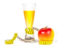 A yellow measuring tape wrapping red apple and juice Royalty Free Stock Photo