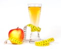 A yellow measuring tape wrapping red apple and juice Royalty Free Stock Photo