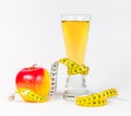 A yellow measuring tape wrapping red apple and juice Royalty Free Stock Photo