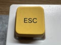 Yellow mechanical exit button on white mechanical keyboard for programmers and for remote work top view Royalty Free Stock Photo