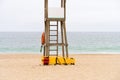 Yellow medical backboard and life ring on wooden lifeguard tower Royalty Free Stock Photo