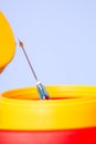 Yellow medical disposal waste box, syringe needle with red drop on the tip Royalty Free Stock Photo
