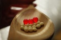 Yellow medical pills and red vitamins a wooden spoon, closeup on the table, side view Royalty Free Stock Photo
