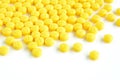 Yellow medicine tablets (or pills) on white background