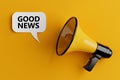 Yellow Megaphone with Good News Sign on a Speech Clouds Chat Bubble. 3d Rendering Royalty Free Stock Photo