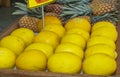 Yellow melon. Many melons to be sold and pineapple in the background