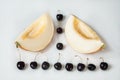 Compisition on white background with fruit. Melon and cherrys