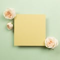 Yellow memo pad with rose flowers on green background Royalty Free Stock Photo