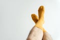 Yellow mens socks on his feet on a white background .