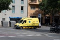 Yellow Mercedes Benz Sprinter ambulance van parked in front of a building