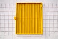 Yellow mesh shutter on white wall