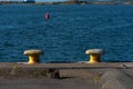 Yellow metal bollards by a dock