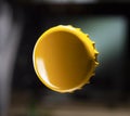 Metal disposable yellow enameled bottle cap. Close-up view. Royalty Free Stock Photo