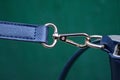 Yellow metal carabiner with a ring with blue leather harness