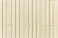 Yellow metal corrugated sheet with vertical stripes. Construction and repair. Background. Space for text Royalty Free Stock Photo