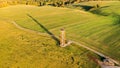 Yellow metal lookout tower in the middle of the fields in hilly landscape, aerial photo, Czech Republic