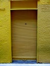 Yellow metal roller shutter door at Vancouver, Canada Royalty Free Stock Photo