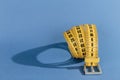 Yellow meter belt slimming on a blue