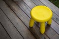 Yellow mini chiar on wooden floor for sit Royalty Free Stock Photo