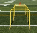 Yellow mini hurdles and orange cones on green turf field Royalty Free Stock Photo